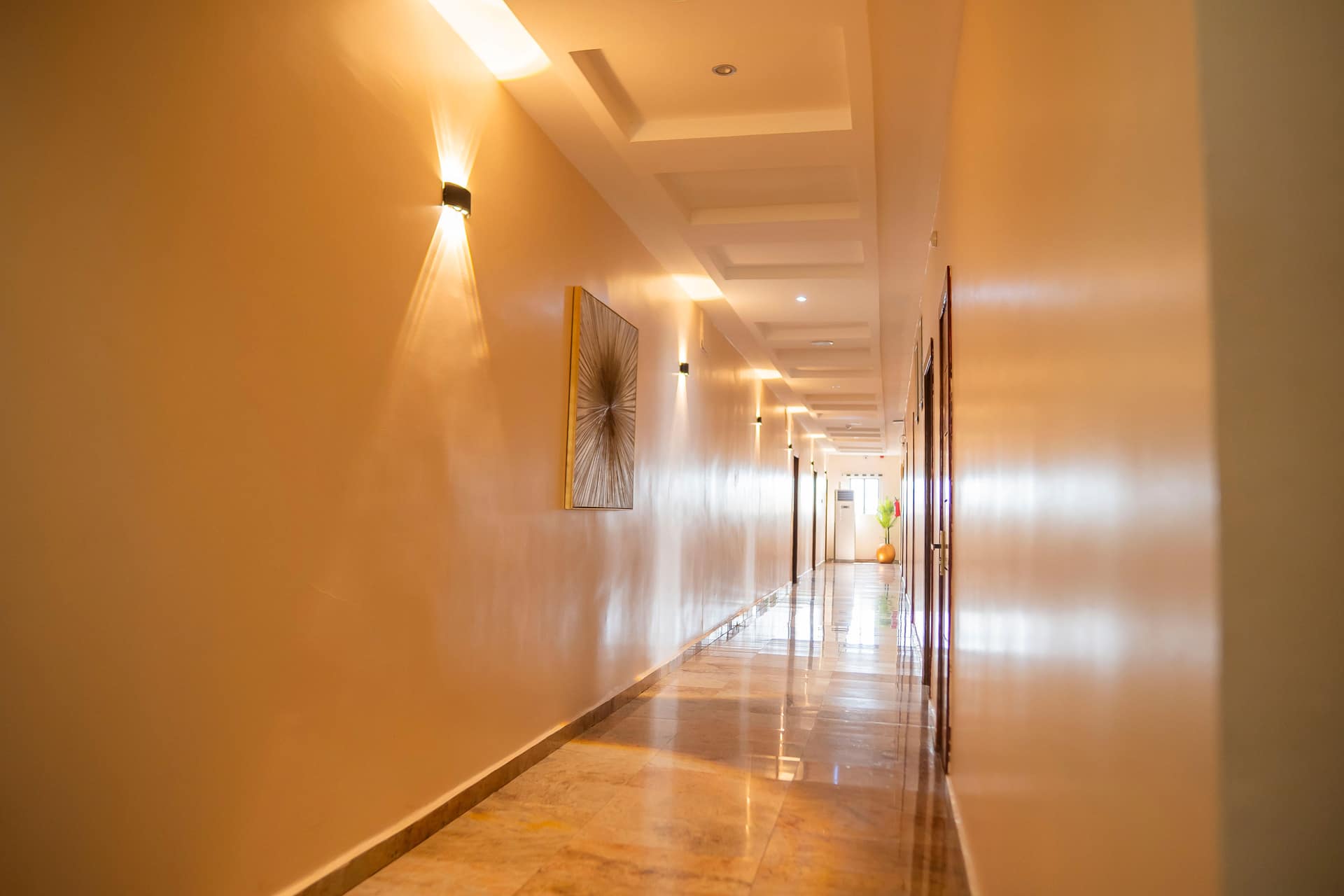 Warmly lit corridor with marble floors
